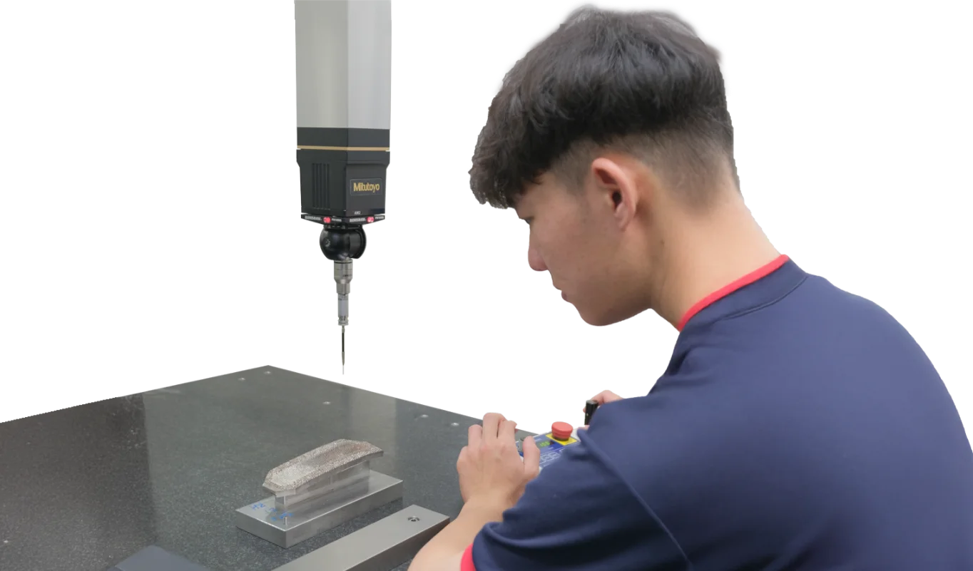 Technician using a Mitutoyo CMM (Coordinate Measuring Machine) touch probe to inspect the surface geometry of an electroformed mold core.
